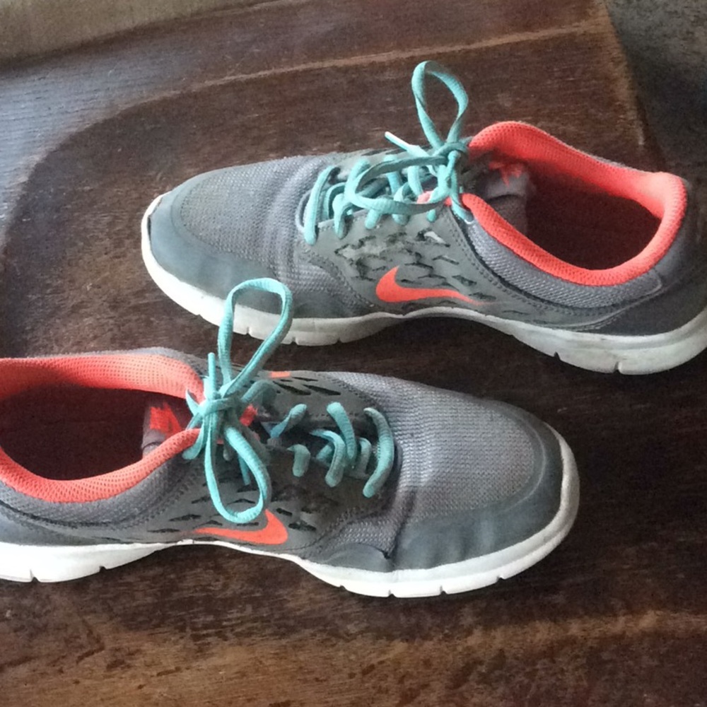 Pink, Blue and Grey Nike women’s running shoes.